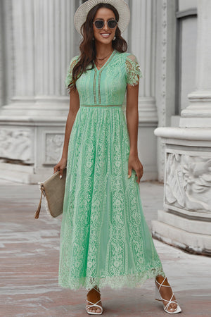 Lace midi dress in mid green with short sleeves, V-neck, and scalloped hem.