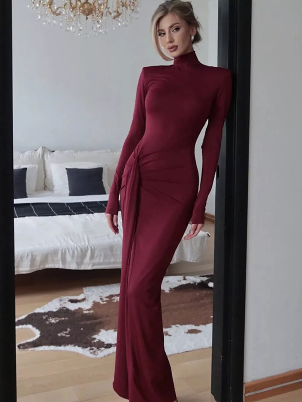 Burgundy turtleneck maxi dress with long sleeves and a ruched tie detail on the side.