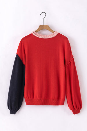 Red sweater with black balloon sleeves and pink trim