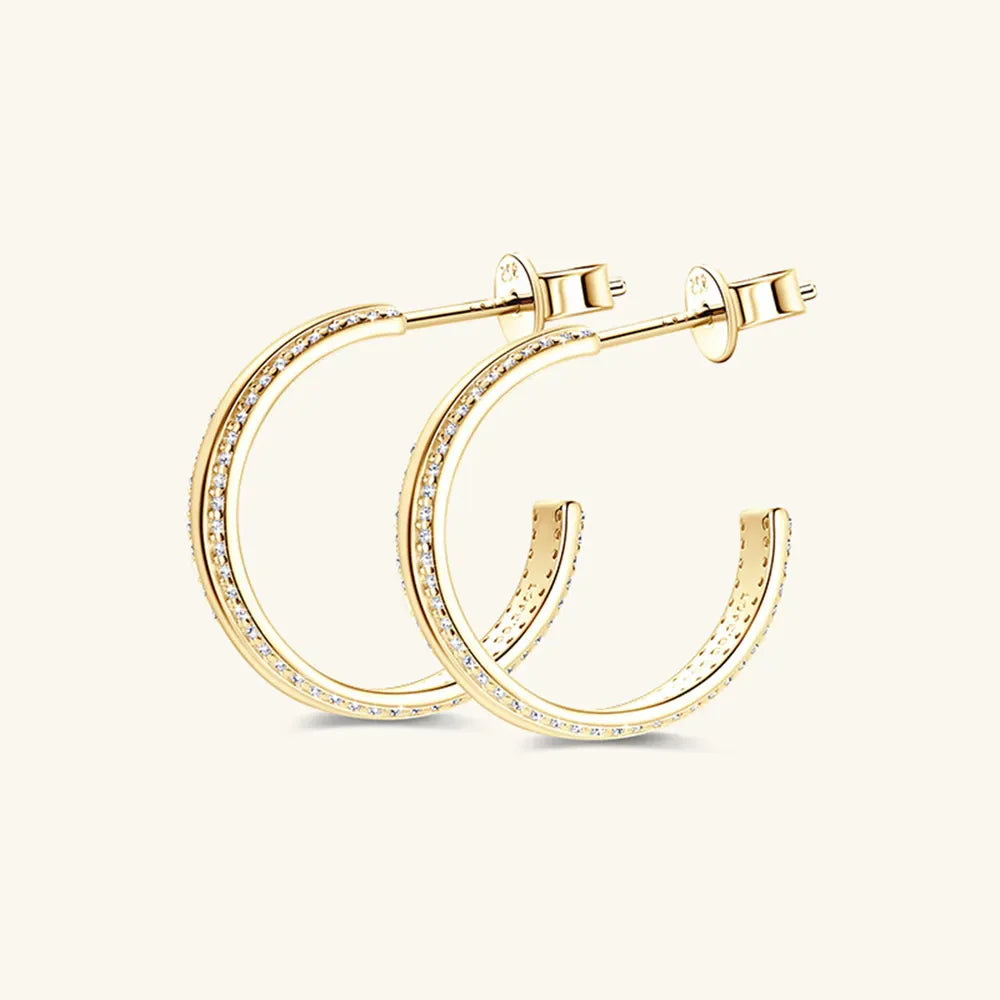 Gold pavé moissanite C-hoop earrings in sterling silver with D color grade stones.