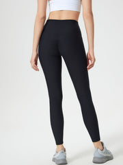 Black ribbed high-waist leggings with ruched detail on the back.