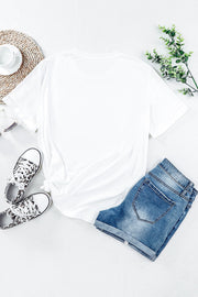 White t-shirt with rolled sleeves and a knotted hem, styled with denim shorts and leopard print sneakers.