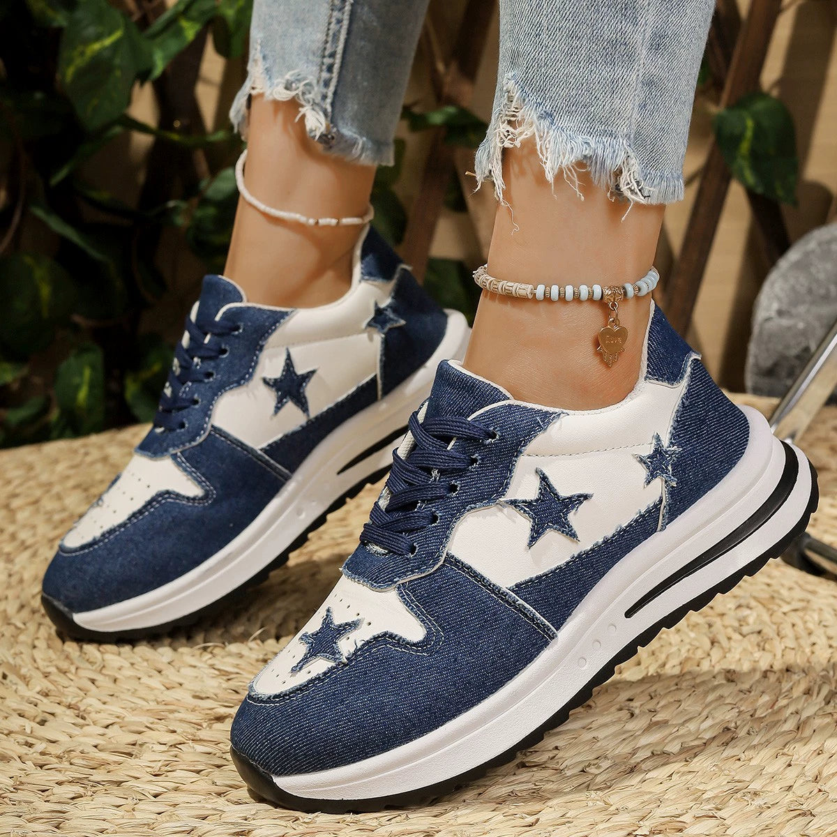 Blue and white denim sneakers with star embellishments and a chunky sole.