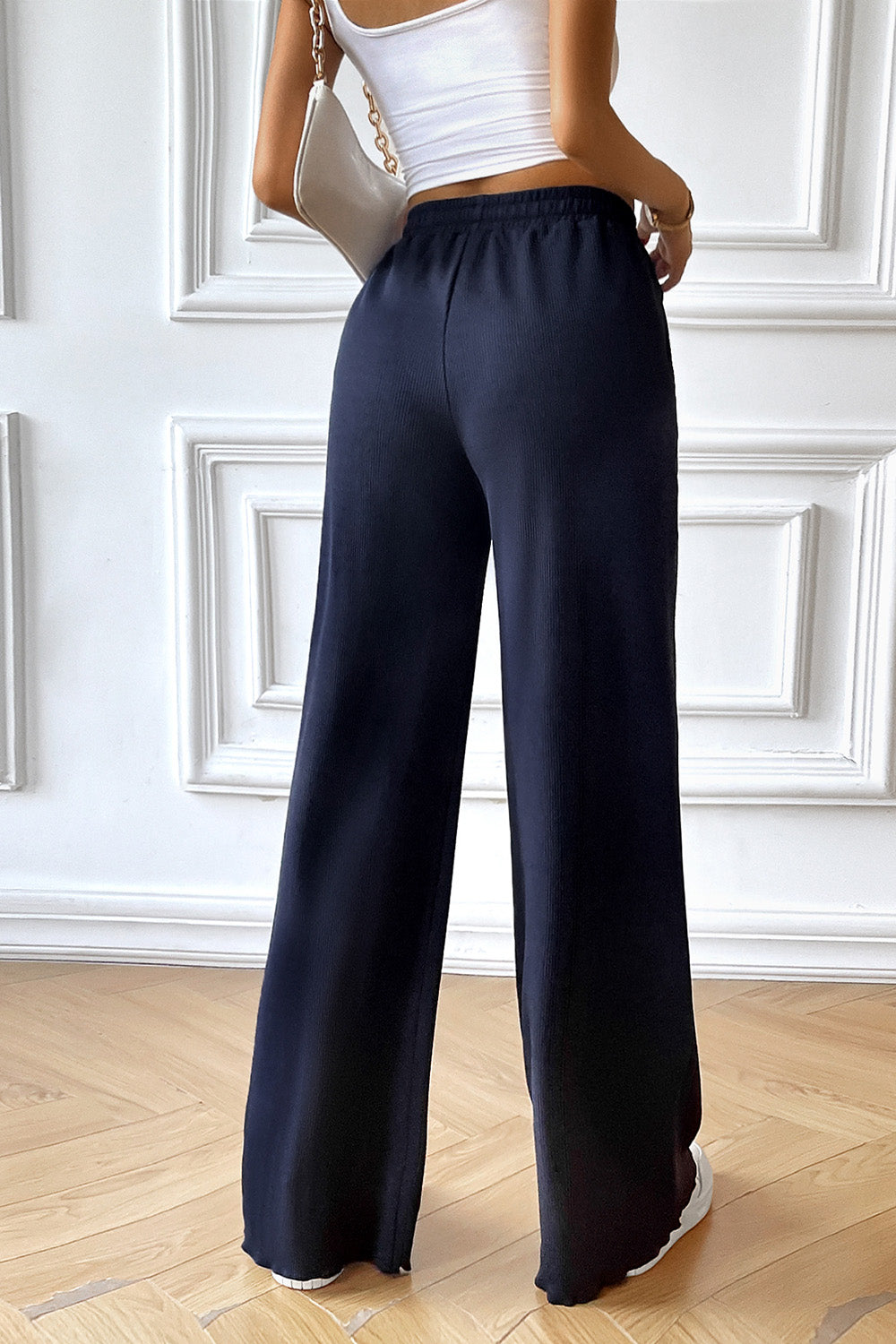 Dark blue textured rib wide-leg drawstring trousers with a comfortable fit.