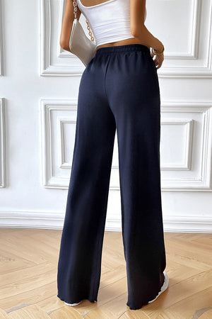 Dark blue textured rib wide-leg drawstring trousers with a comfortable fit.