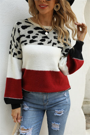 Leopard patchwork knit sweater with balloon sleeves, colorblocked in red, white, and black.