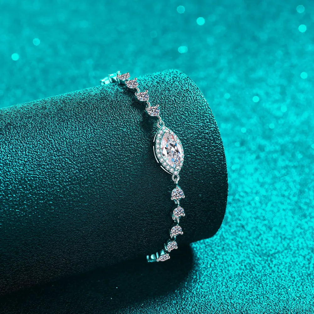 Silver adjustable bracelet with a central marquise-cut crystal and smaller cluster charms.