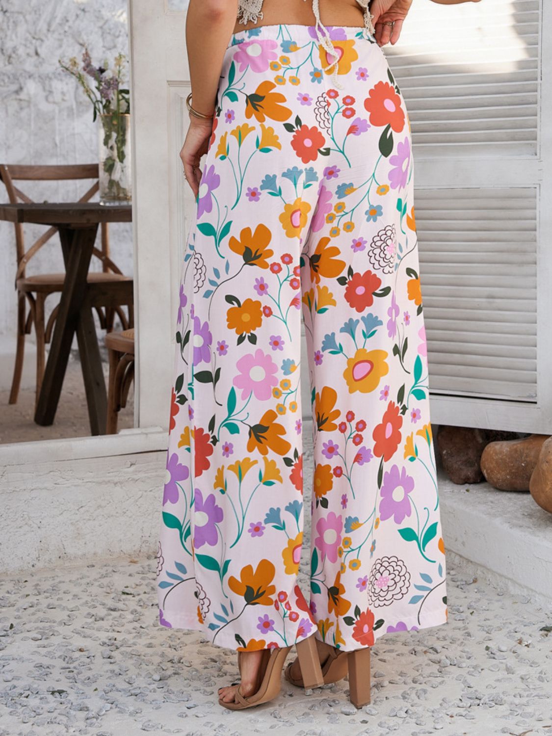 Wide-leg trousers in multicolor floral print with drawstring waist.