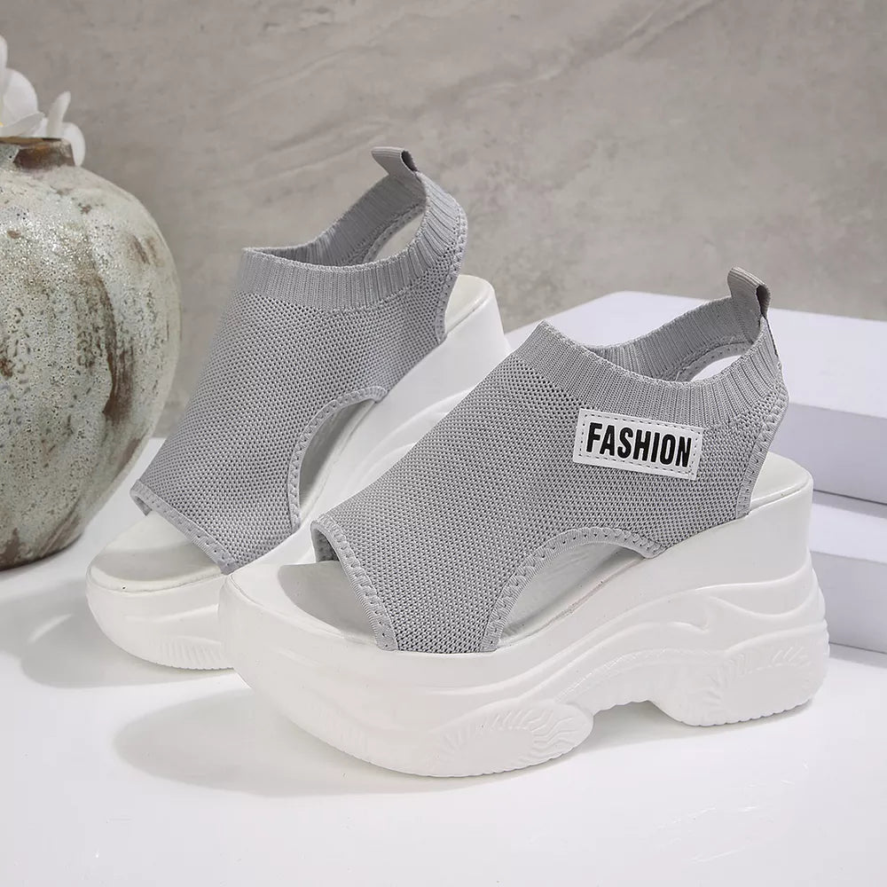 Fashion-forward gray open-toe wedge sandals with chunky white soles and "FASHION" label.