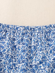 Baby blue floral print cotton set with smocked waist detail.