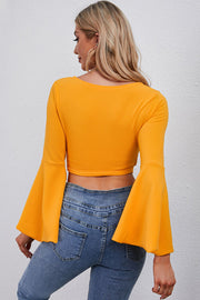 Pumpkin wrap tie bell sleeve crop blouse with a square neckline.