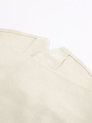 Buttoned vest and shorts set in natural cotton fabric with visible stitching details.