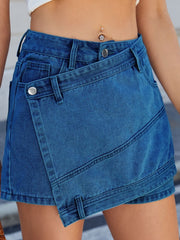 Light blue denim skort with wrap-effect front and angled seams.