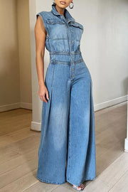 Denim jumpsuit with collared neckline, button-front, cinched waist, and wide legs.
