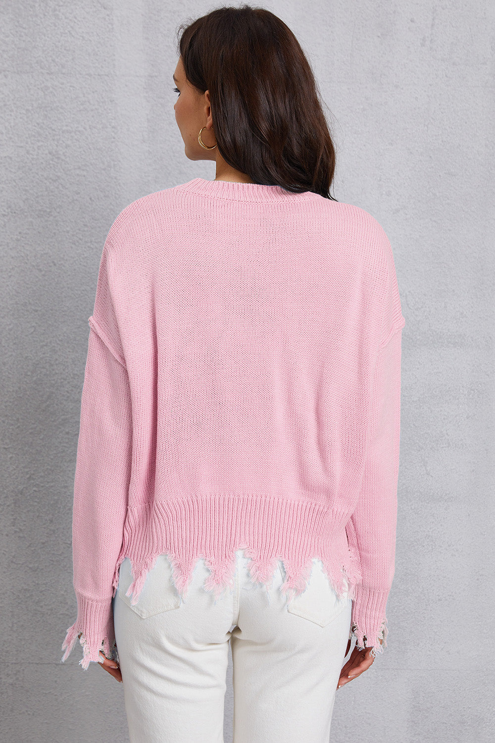 Blush pink knit sweater with distressed hem and cuffs.