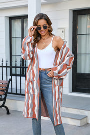 Wave Stripe Longline Knit Cardigan in rust and black acrylic blend with pockets and open front.