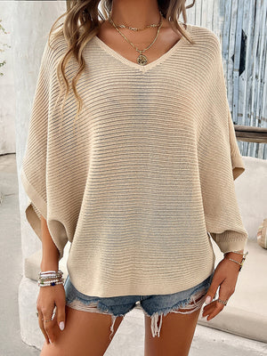 Tan open-knit dolman sleeve v-neck sweater with a relaxed fit.