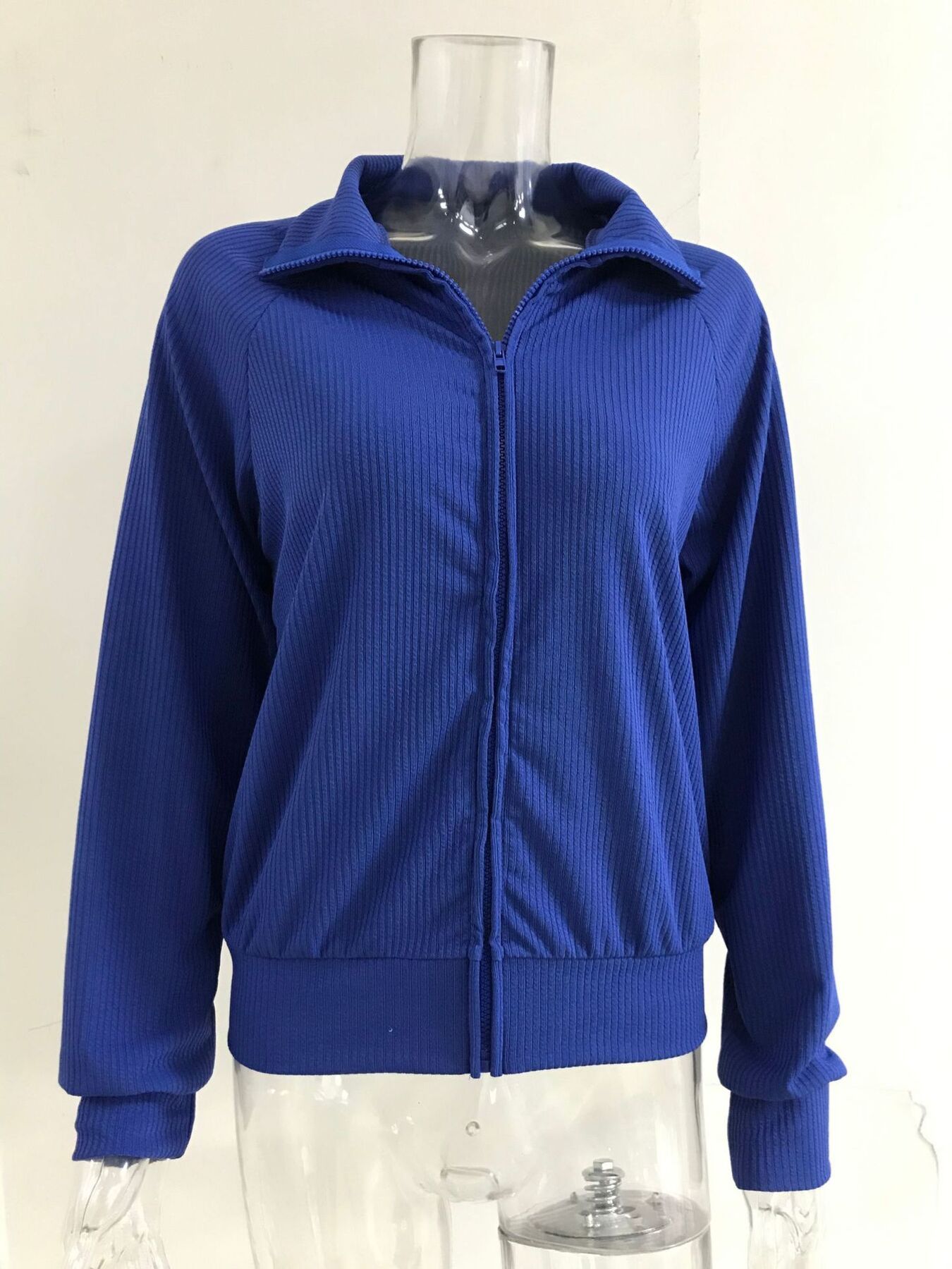 Blue ribbed knit zip-up jacket with collar and long sleeves