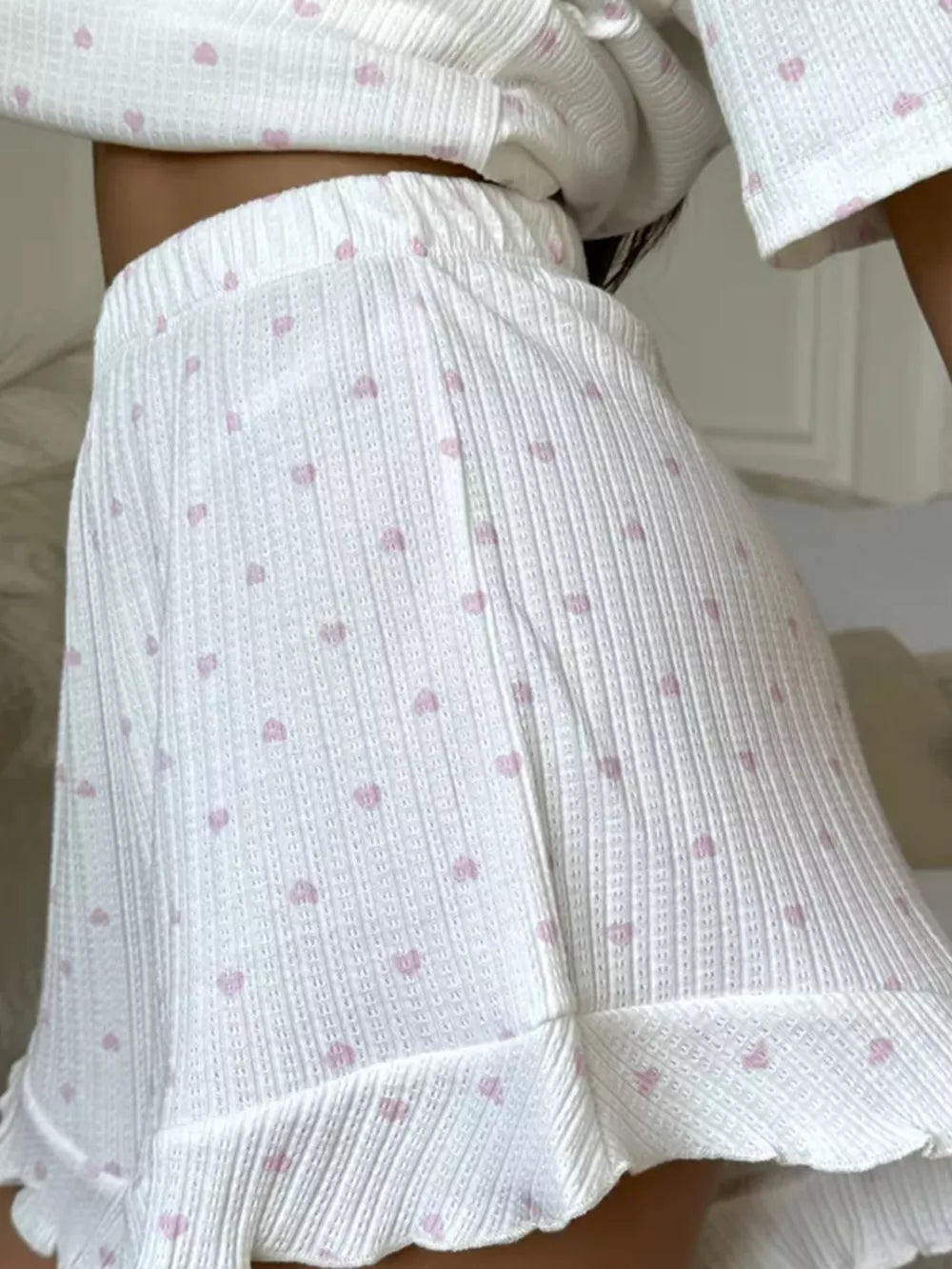 White cotton blend lounge set with pink hearts, ruffled hem shorts and cropped top.