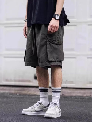 Army green cargo shorts with drawstring waist and button flap pocket.