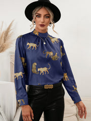 Royal blue leopard print blouse with keyhole neck and long sleeves.