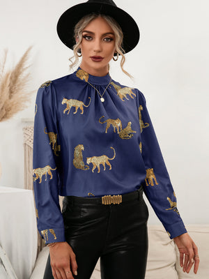 Royal blue leopard print blouse with keyhole neck and long sleeves.