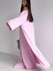 Blush pink maternity one-piece swimsuit with off-the-shoulder neckline and long sleeves.