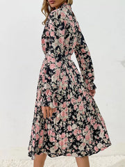 Black floral pleated midi dress with long sleeves and a high neckline.