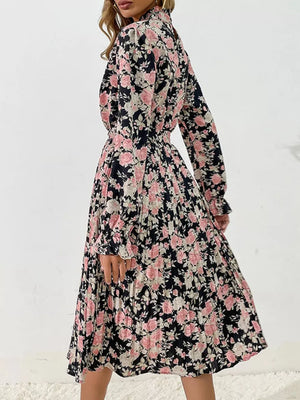 Black floral pleated midi dress with long sleeves and a high neckline.
