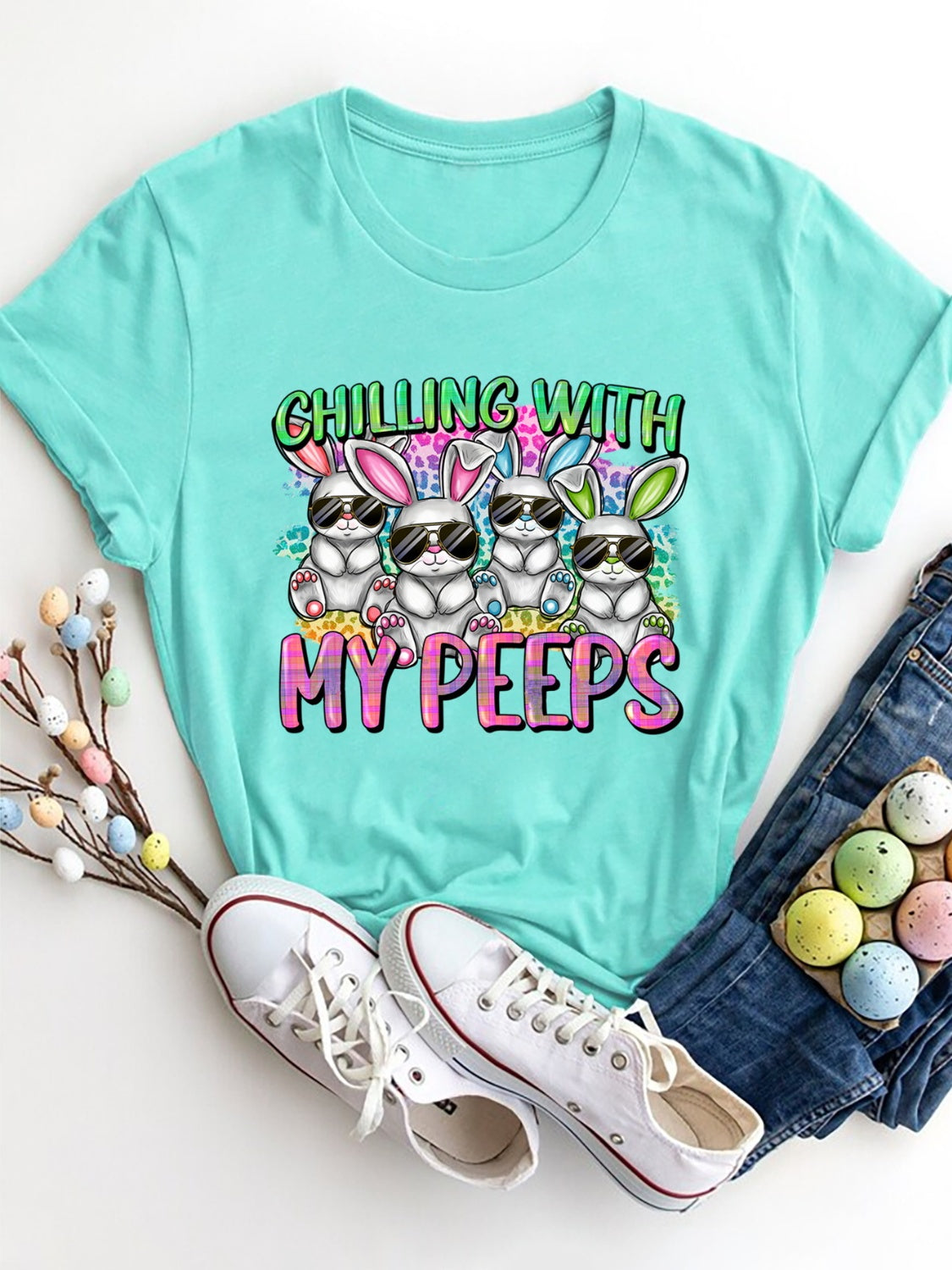 Aqua graphic t-shirt with cartoon bunnies wearing sunglasses and the text My Peeps.