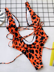 Tangerine snakeskin plunge swimsuit with lace-up back detail
