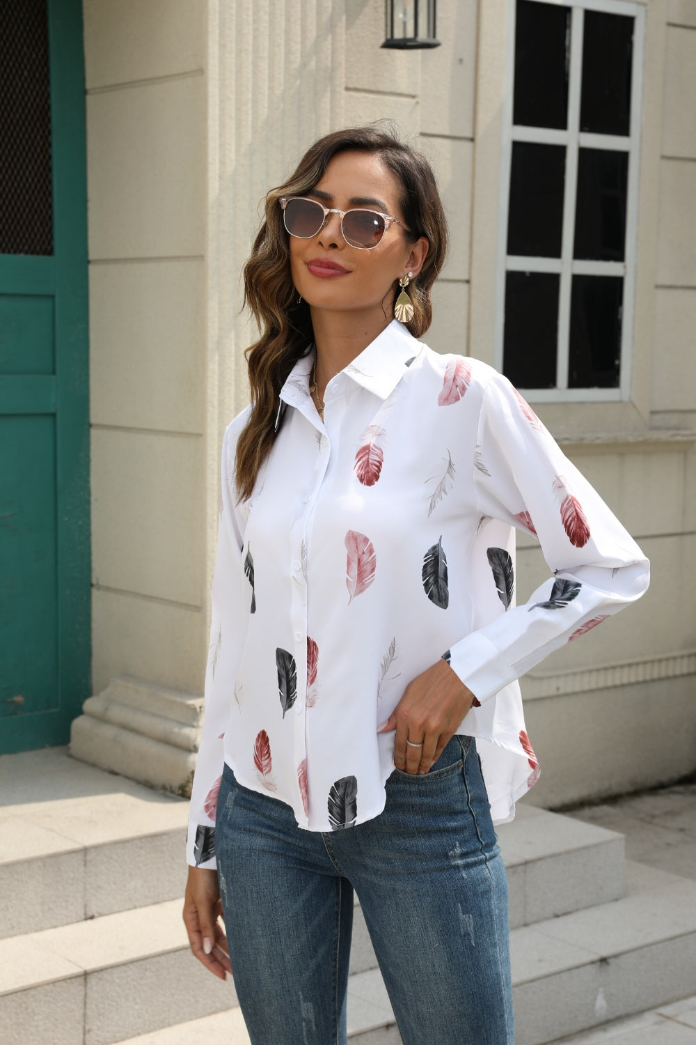 White feather print button-down shirt with long sleeves and a collared neckline.