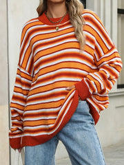 Oversized striped knit sweater in orange, white, and red.