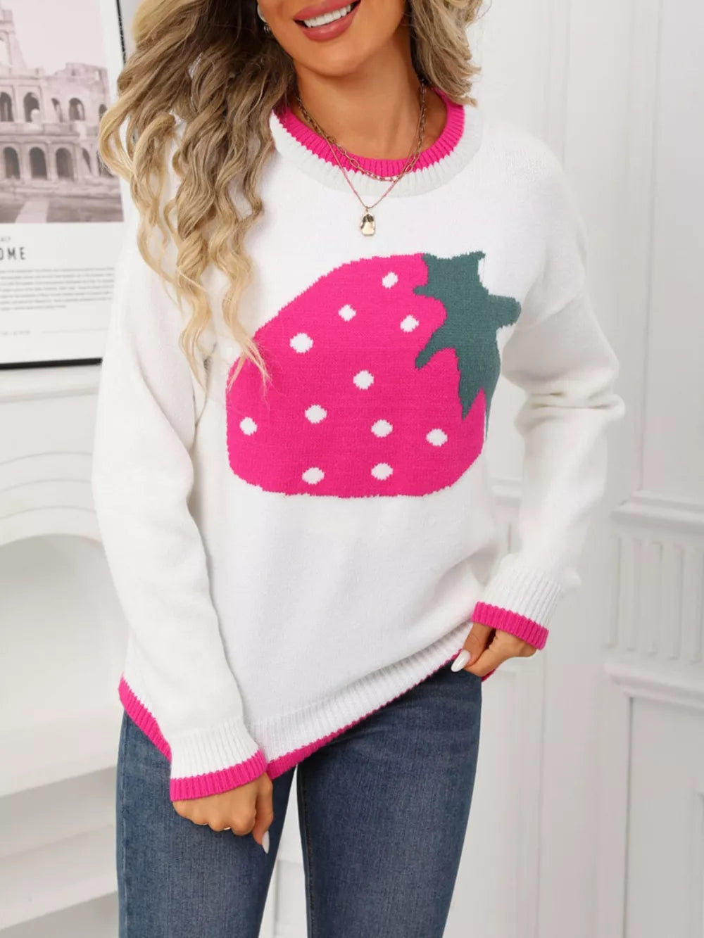 White acrylic blend sweater with large pink strawberry graphic and contrast trim.