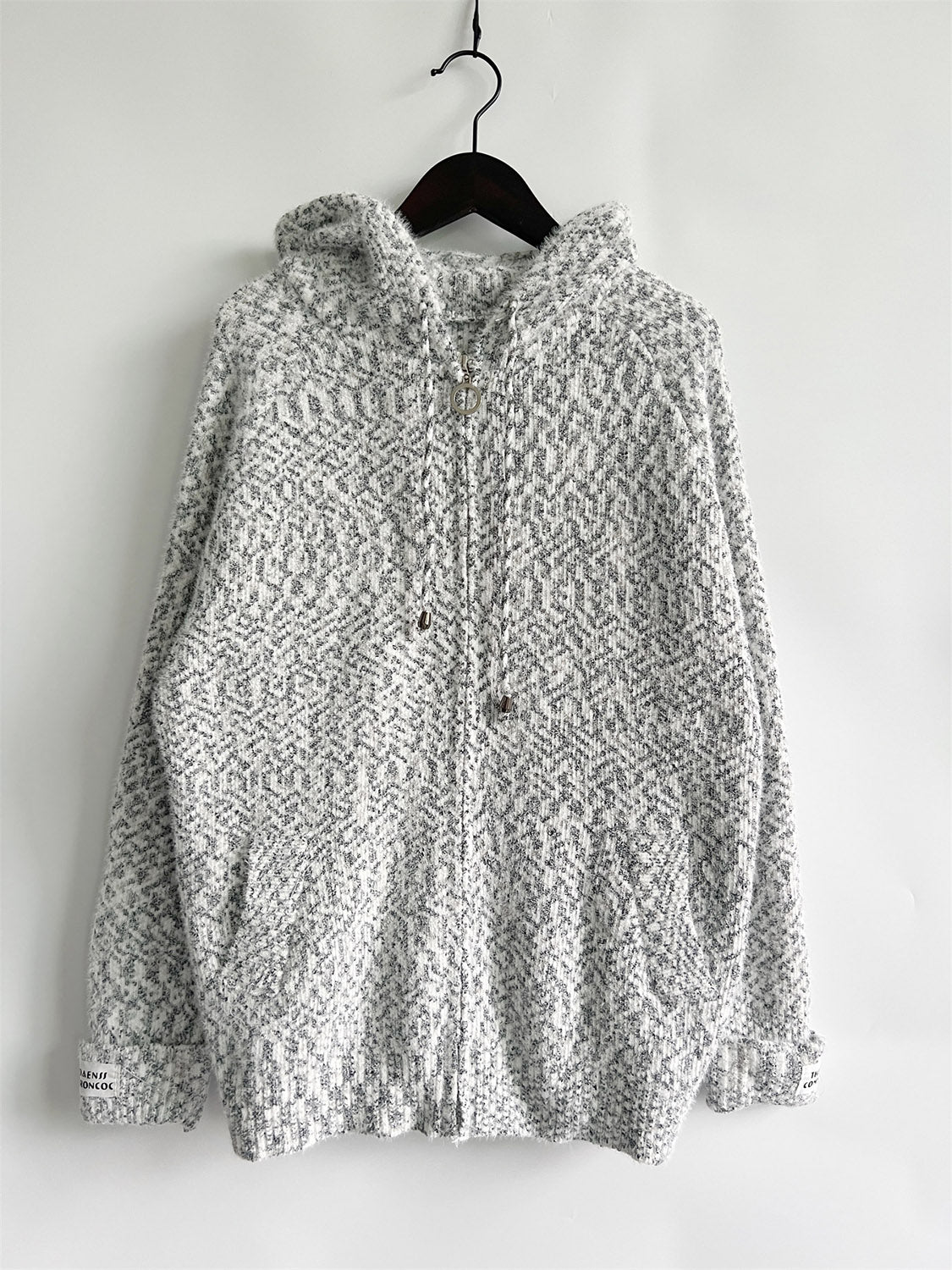 Speckled knit relaxed zip-up hoodie in white with a geometric pattern and drawstring hood.