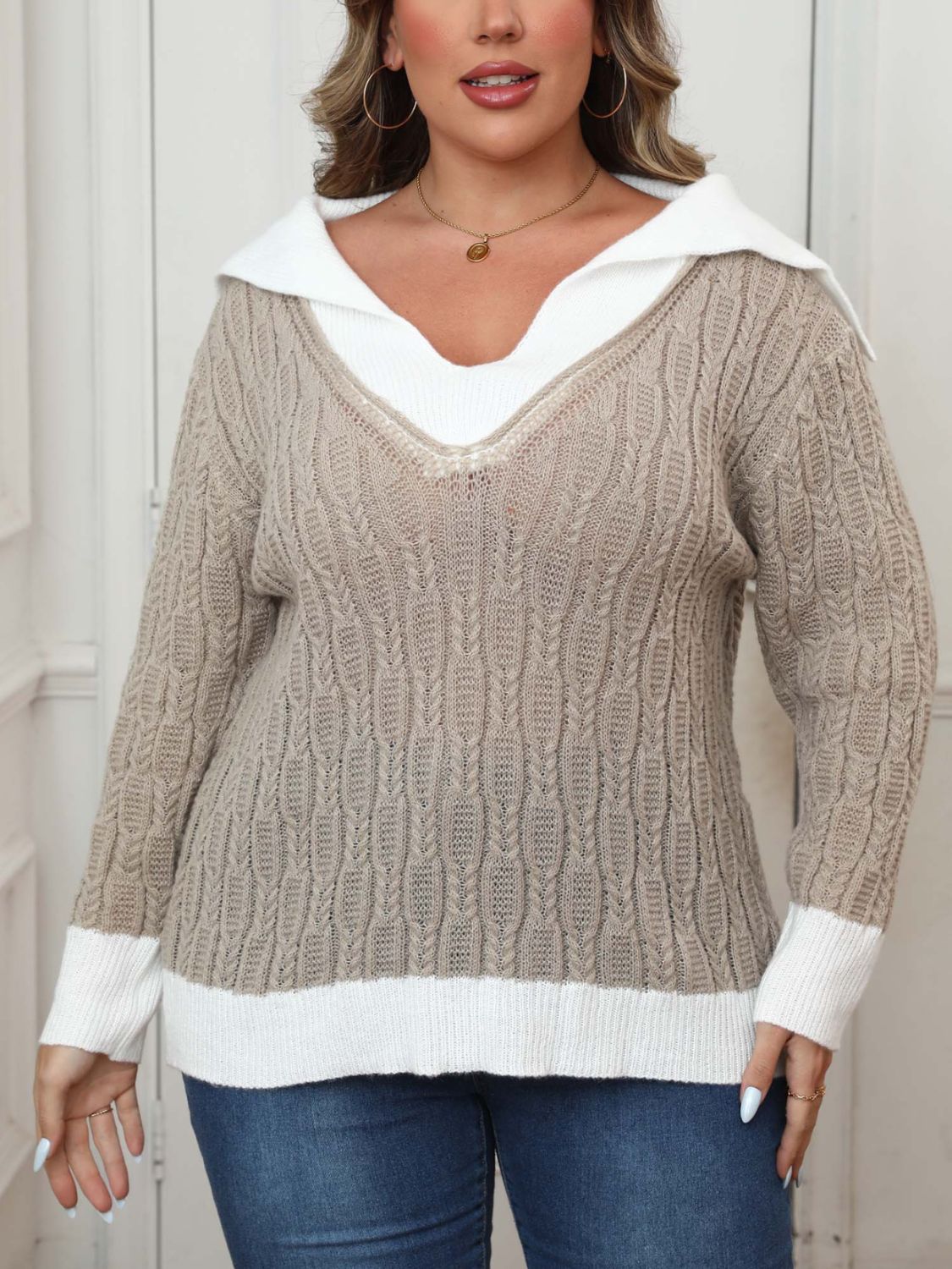 Khaki cable knit sweater with white contrast collar and cuffs.