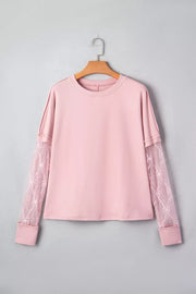 Pink maternity t-shirt with lace sleeves featuring bow details and crew neck.