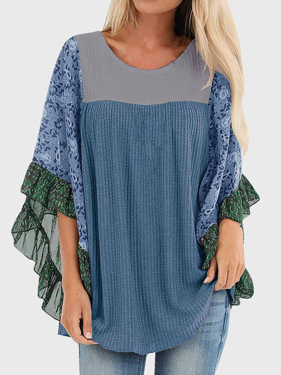 Textured panel blouse in dusty blue with floral print flutter sleeves and green ruffle trim.