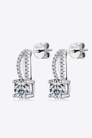 Silver stud earrings with a curved halo of small stones and a central 1ct moissanite.