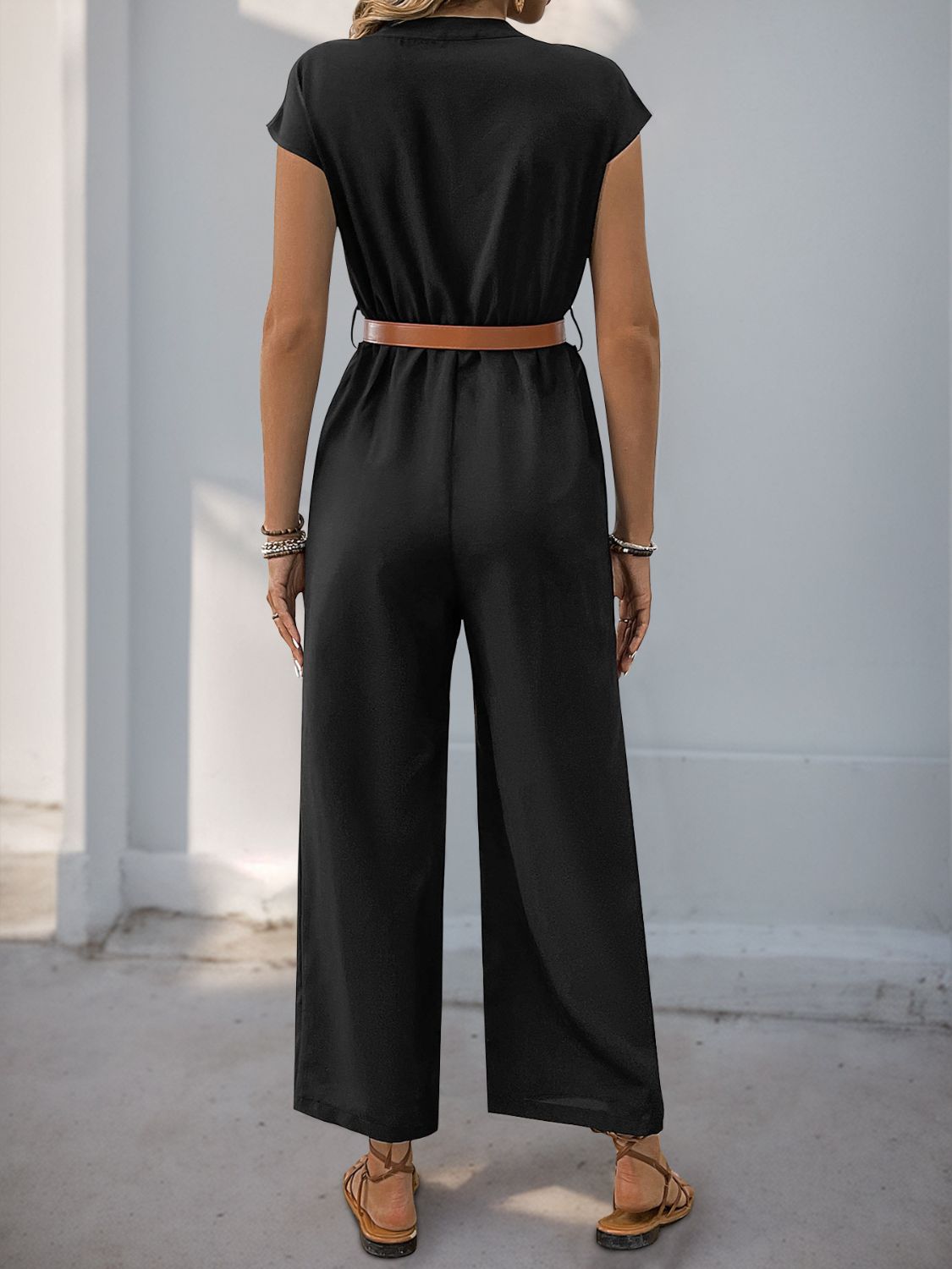Black cap-sleeve button-down wide-leg jumpsuit with a brown belt