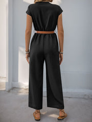 Black cap-sleeve button-down wide-leg jumpsuit with a brown belt