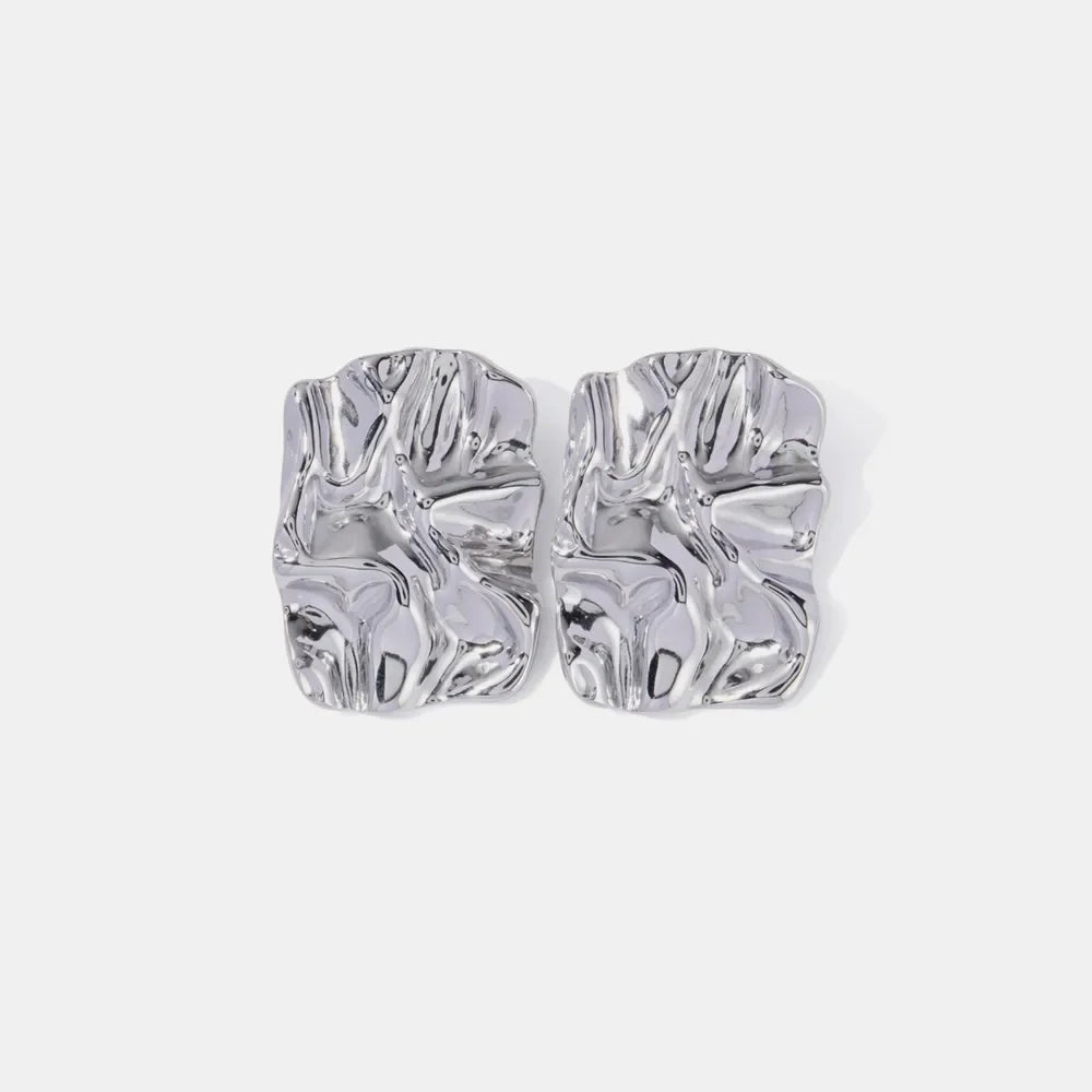 Textured silver sculptural stud earrings with an artistic, crinkled finish.