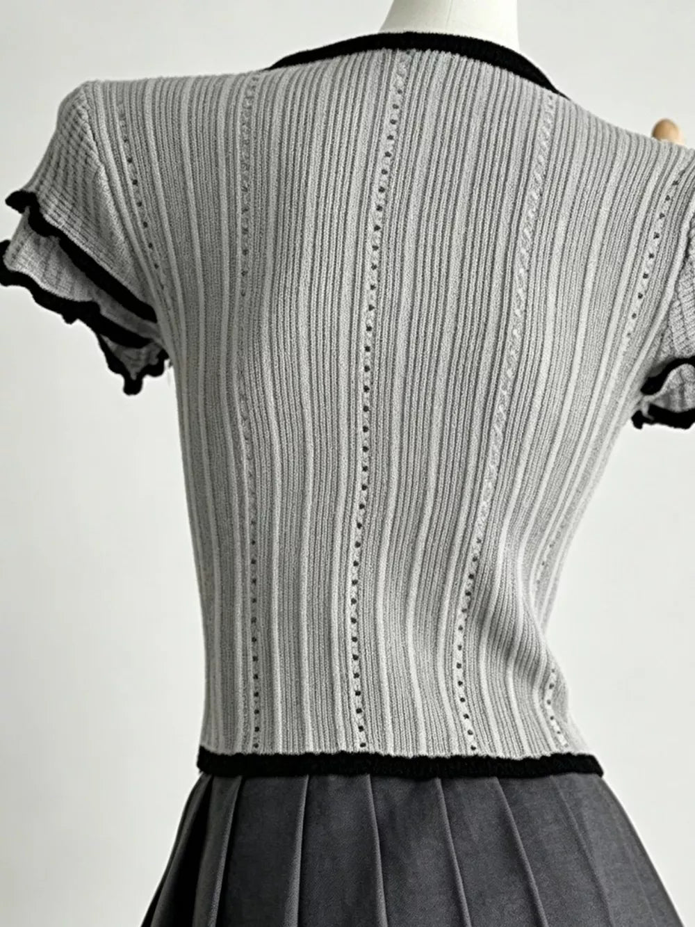 Gray ribbed maternity t-shirt with black frill collar and sleeve details.