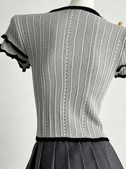 Gray ribbed maternity t-shirt with black frill collar and sleeve details.