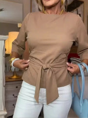 Camel tie-waist t-shirt with 3/4 sleeves and a boatneck, styled with white pants.