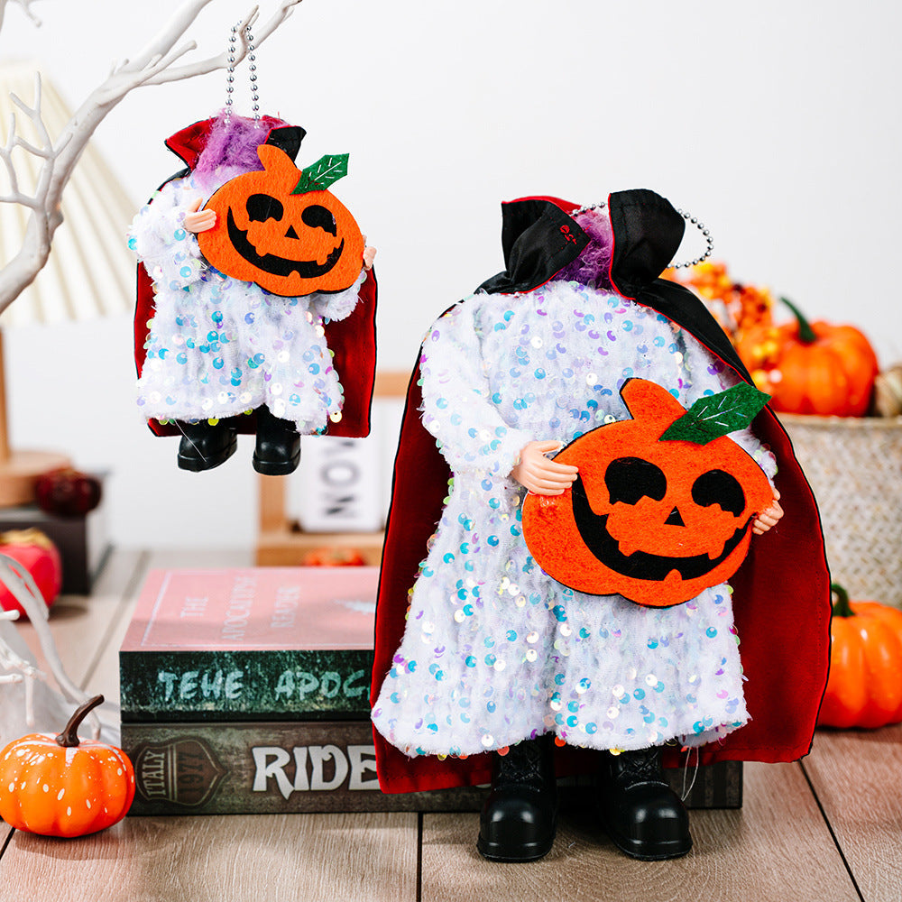 Halloween doll in white sequin dress, red cape, holding pumpkin.
