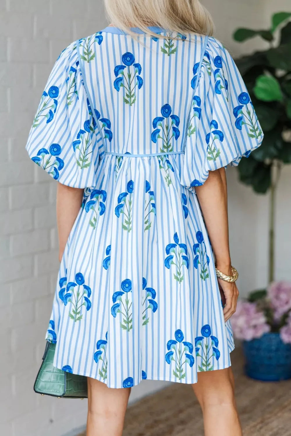 Floral stripe puff sleeve mini dress with blue floral print and adjustable waist.