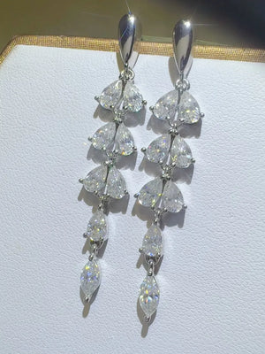 Cascading moissanite pear drop earrings in silver with multiple shimmering pear and marquise-cut stones.