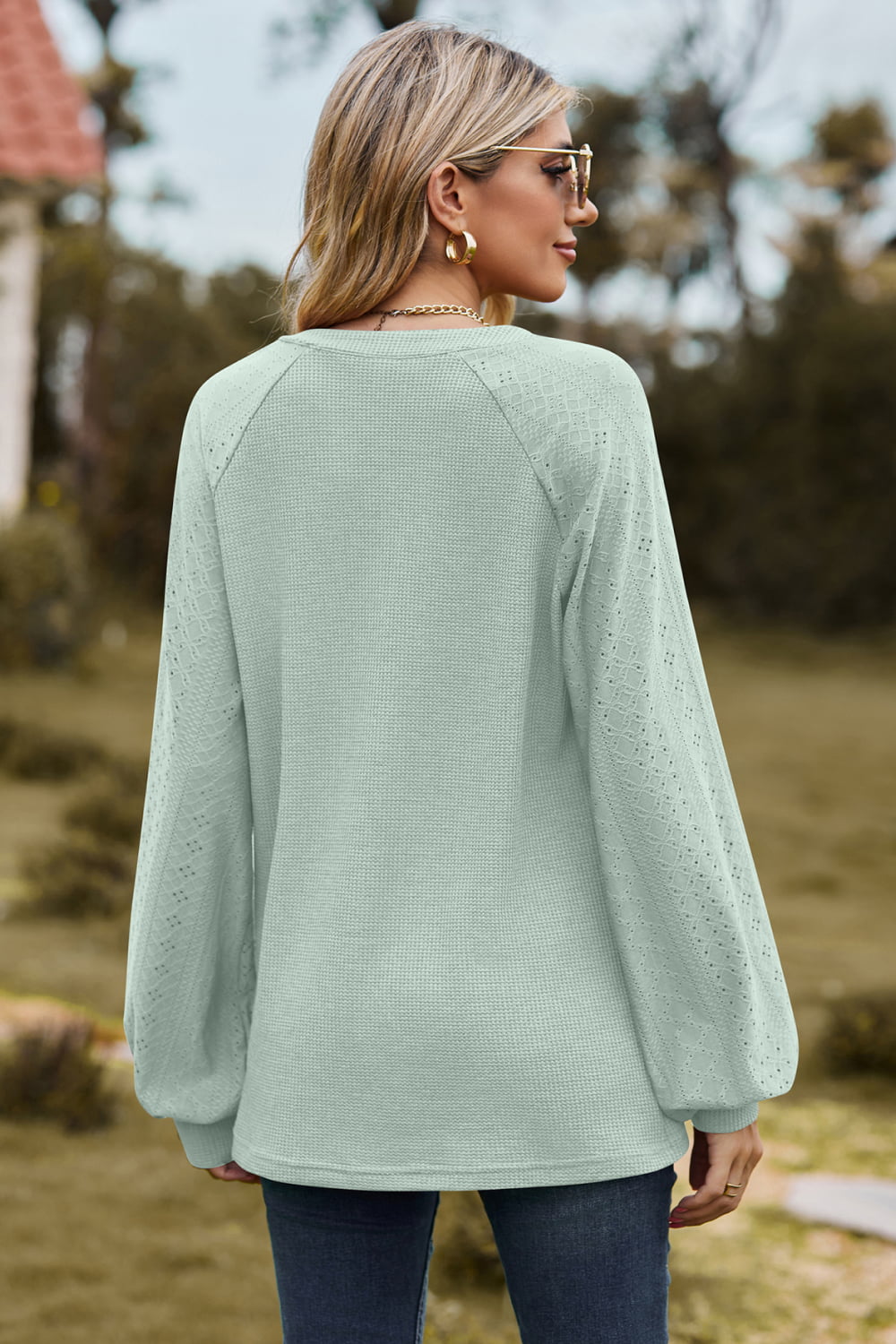Light green waffle knit raglan sweater with laser cut sleeves