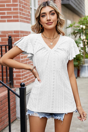 White eyelet flutter sleeve blouse with V-neck and ruched detail.
